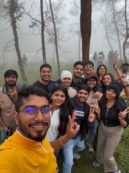 A fun group selfie taken in the misty forest, capturing the joy of the moment.