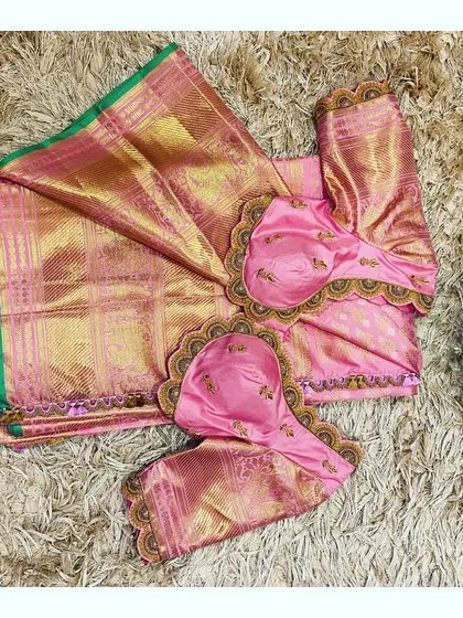 A beautiful pink Kanjeevaram saree paired with a custom blouse featuring a stunning scalloped and embroidered back design.