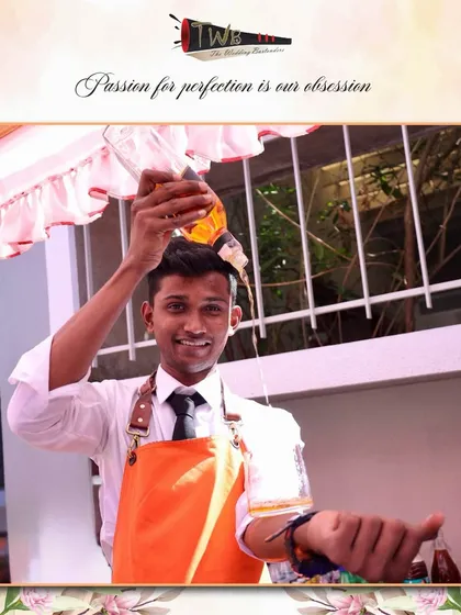 A bartender demonstrates a flair pour, adding an element of entertainment to the bar service.