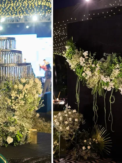 A crystal cake stand repurposed as a floral installation and a modern floral arch against a black backdrop. These are examples of unique, custom-designed decor elements.