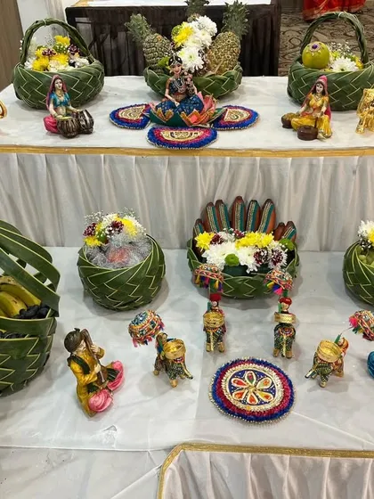 A beautiful display of eco-friendly fruit baskets and miniature decorative items for a baby shower table setup.