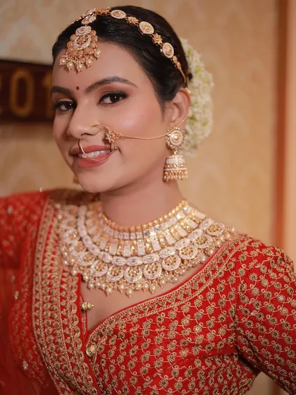 A close-up of this smiling bride. Her makeup is natural and glowing, perfect for her simple and elegant look.