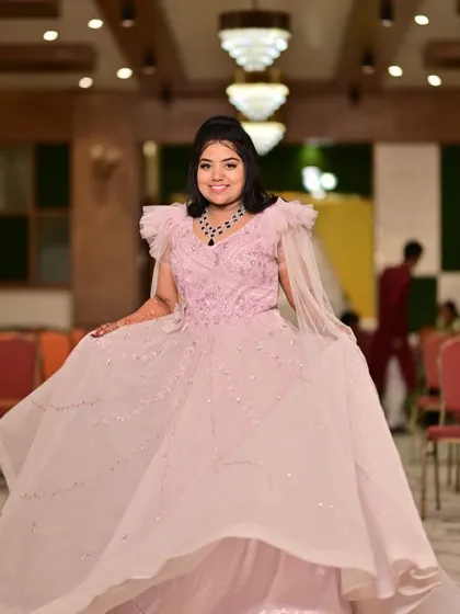 A twirl to show off this beautiful pink engagement gown. The ruffled shoulders and flowing skirt are perfect for a bride-to-be.