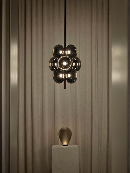 The Aeris pendant is paired with the Solace table lamp, demonstrating how different pieces from the same designer can be used together to create a harmonious lighting scheme.