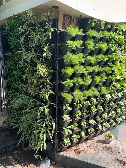This living wall was designed to wrap around an outdoor pillar, turning a structural element into a column of greenery. It's a great way to integrate plants into your home's architecture.