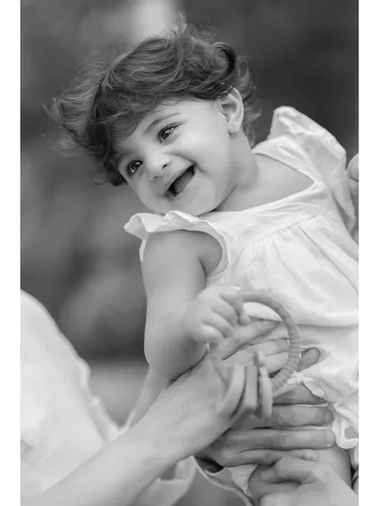 This black and white shot captures the pure happiness on baby Anwita's face as she plays with her parents. It's a memory of pure, simple joy.