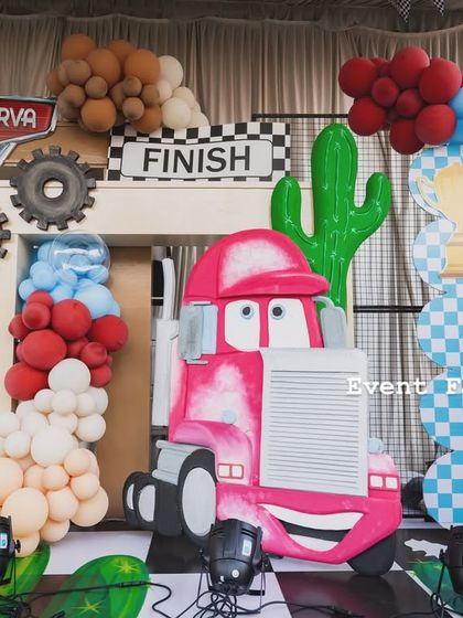 A close-up of a pink tow truck character, likely Flo, from the Disney Cars setup, adding a fun and recognizable element for the kids.