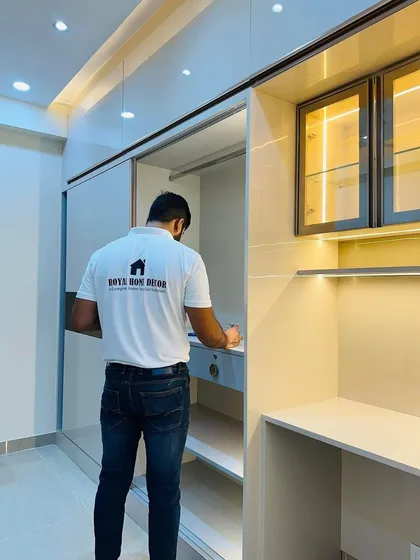 Inspecting the interior of the sliding wardrobe, which includes drawers and ample shelving for organized storage.