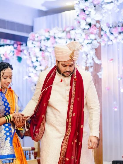The couple taking their first steps together as husband and wife, a significant moment captured against a beautiful floral backdrop.
