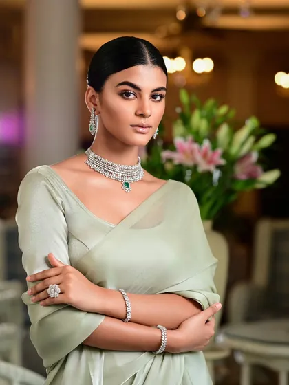 A high-end jewellery campaign featuring a model in a diamond and emerald necklace set. The clean, elegant styling and soft lighting ensure the jewellery is the star of the show.