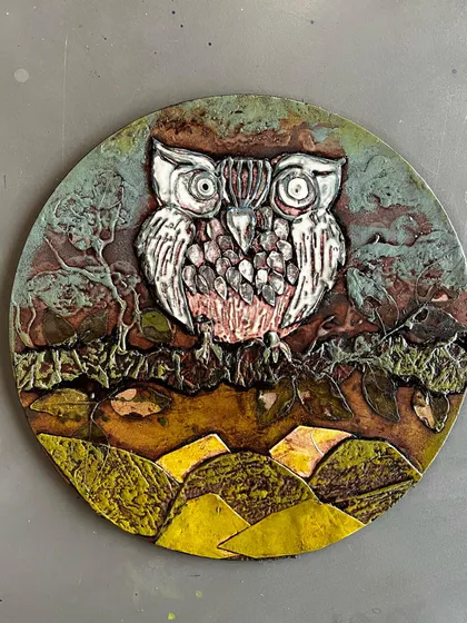 This is a close-up of a finished collagraph plate, ready for printing. The artist used various materials to build up this incredible owl design, creating a piece full of rich texture that will translate beautifully into a print.