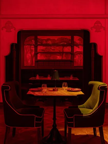 An intimate table setting, where the unique silhouettes of the chairs and the rich textures create a sophisticated and romantic mood.