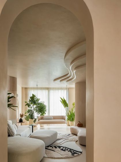 A view through an archway in the "House of Mousse," showing how we use architectural elements to frame spaces and create a sense of discovery. The flowing ceiling and soft furnishings maintain a cohesive, organic feel.