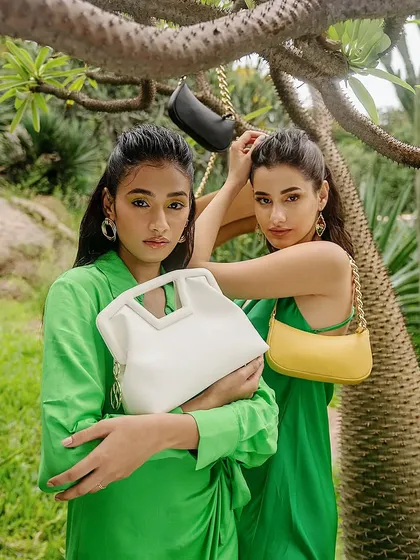 A vibrant outdoor campaign for sustainable fashion brand Sarjaa. This image showcases multiple products and models in a natural setting, emphasizing the brand's eco-friendly ethos with a fresh, modern aesthetic.
