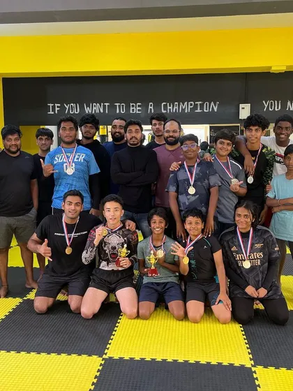 This is our team after a fun in-house jiu-jitsu competition. We believe in pushing each other to get better, and events like these build confidence and team spirit. You can see the mix of kids and adults, all proud of their hard work.