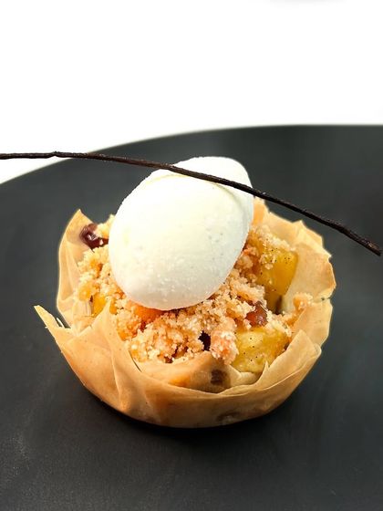 The Kinnaur apple and shakarpara crumble is served in a delicate filo pastry cup with a scoop of homemade vanilla bean ice cream.
