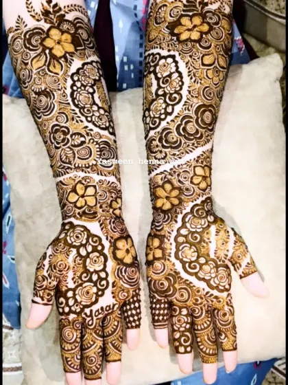 A lovely back-hand design that includes the name 'Yasar' written on the palm, surrounded by floral and paisley patterns.