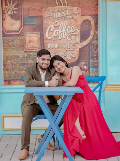 A cozy and romantic moment at a cafe-themed set. The couple's intimate pose and the charming background create a sweet, story-driven image perfect for their pre-wedding album.
