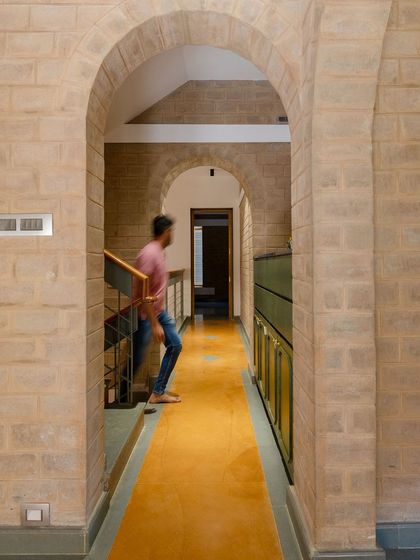 A person moving through the arched corridor, giving a sense of life to the space.
