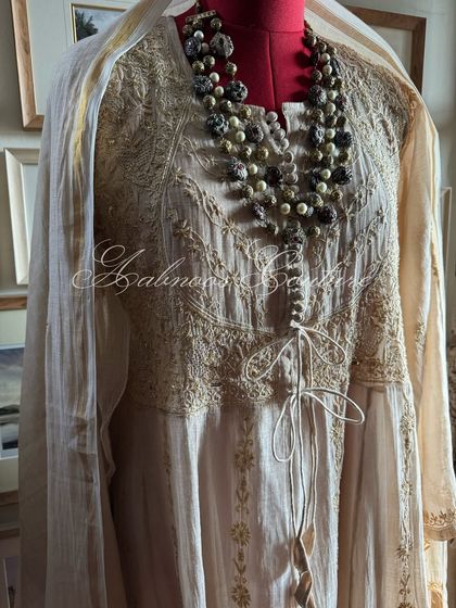 A side view of the Anarkali with its matching dupatta, highlighting the silhouette.