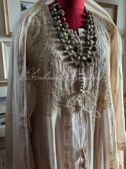 A side view of the Anarkali with its matching dupatta, highlighting the silhouette.