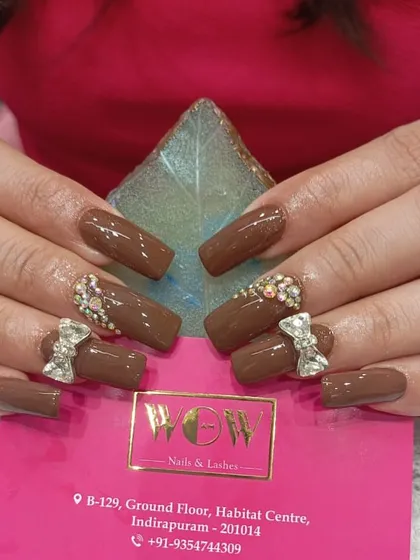 Indulge in this rich, chocolate-brown set of square extensions, accented with intricate 3D bows and sparkling rhinestones. It’s a perfect example of how we can turn your nails into a sweet masterpiece.