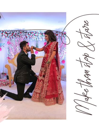A truly romantic wedding portrait. The groom in a classic black tuxedo proposes to his bride, who looks radiant in a traditional red bridal lehenga.