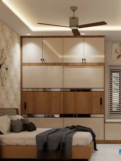 A full view of the bedroom, showing the balance between the textured wall, the modern wardrobe, and the study area.