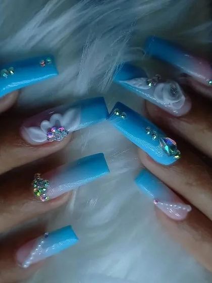 Another look at the highly embellished blue ombré 3D floral nails, highlighting the sparkle and dimension.