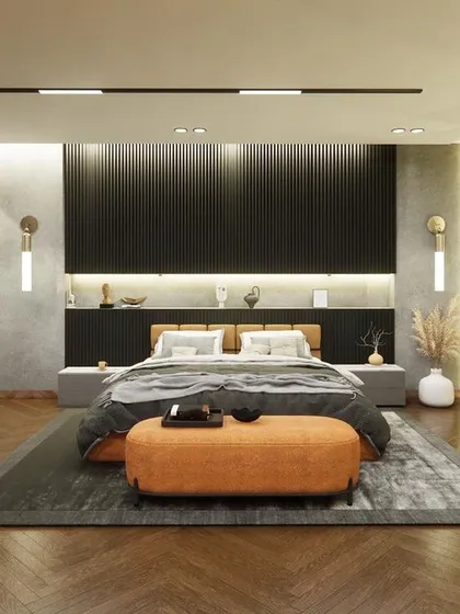 A wider shot of the ongoing bedroom project in Noida. The herringbone wooden flooring adds warmth and texture, contrasting beautifully with the cool grey walls and dark, modern furniture.