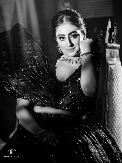 A glamorous black and white portrait of the bride, her sparkling outfit and confident gaze creating a dramatic and captivating image.