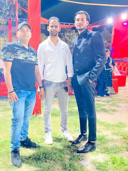 With friends at an outdoor evening event.