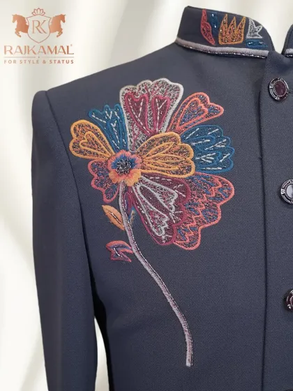 I love blending traditional techniques with modern artistry. This Indo-Western jacket features a bold, multi-colored floral embroidery design on a deep navy blue fabric, creating a statement piece that is both artistic and elegant. This is a perfect example of fusion wear for a reception or festive event.