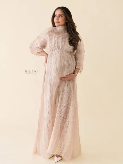 A graceful and poised solo portrait. The high-neck gown and soft lighting give this image a touch of regal elegance.