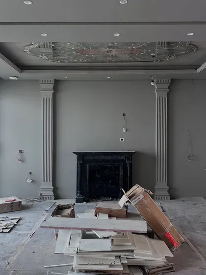 The Gulshan Dynasty living room during the construction phase, with the fireplace and pillars installed but awaiting finishing.