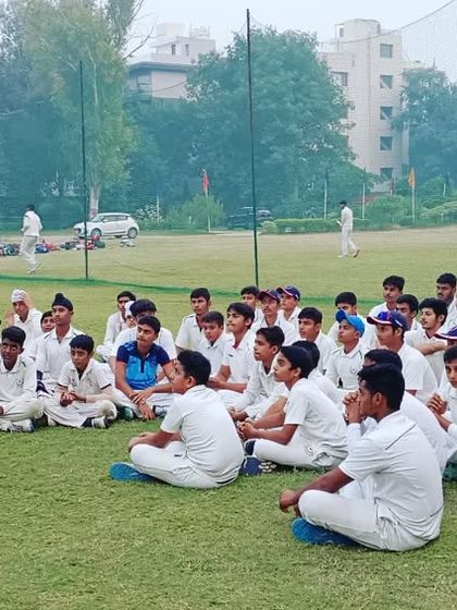 A theory session on the ground for our junior batch. Understanding the game's strategy is as important as playing it.