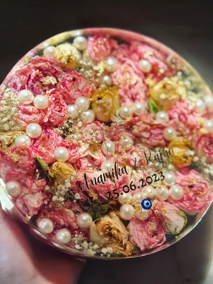 Another look at this lovely pink rose varmala preserved in a circular frame. I always add a little evil eye charm for blessings and protection.