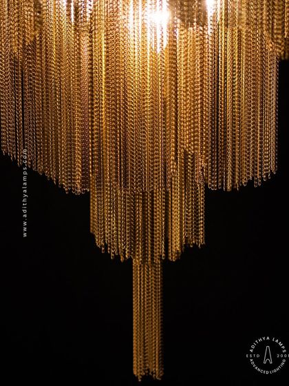 This chandelier makes a bold statement with its cascading antique gold chains. The layers of chains create a fluid, waterfall-like effect that beautifully diffuses the light, adding texture, warmth, and a touch of vintage glamour to your interior.