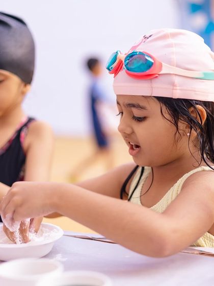 Even in her swim gear, this little girl is enjoying the hands-on fun at the craft table. I plan activities that are accessible throughout the party.