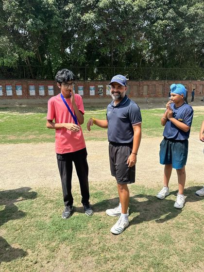 A coach shares a light-hearted moment with a player during the awards ceremony. We maintain a supportive and encouraging environment.