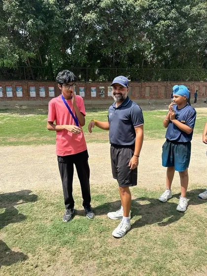 A coach shares a light-hearted moment with a player during the awards ceremony. We maintain a supportive and encouraging environment.