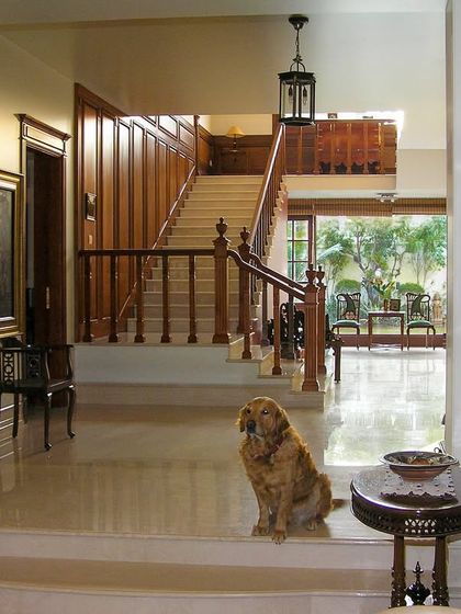 A space defined by warm wooden tones and ornate details. This entryway feels genuinely lived in, with personal touches that make it feel like a true home.