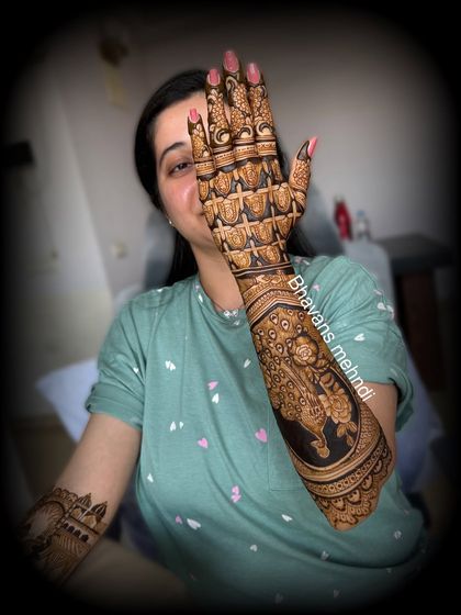 A close up of a beautiful back hand bridal design. This piece features a majestic peacock and a detailed grid pattern, showing the fine line work and shading that goes into my bridal art.