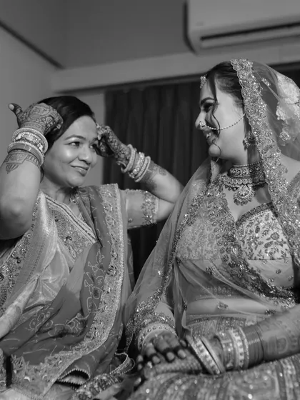 A mother's final touch, adjusting the 'nazar ka tikka' to protect her daughter. This black and white shot is filled with tradition, love, and a lifetime of care.