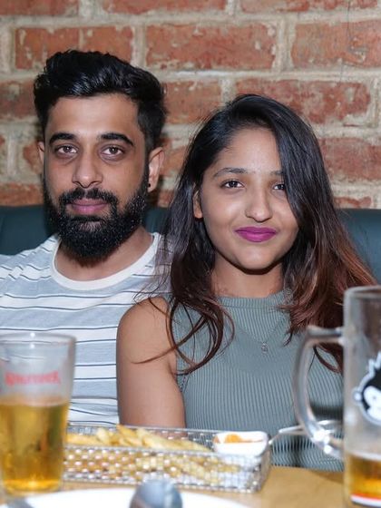 A couple having a casual evening with some drinks and snacks. It's a relaxed environment where you can unwind after a long day or week.