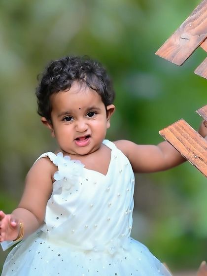 Another beautiful outdoor portrait of the same girl, showing her playful and expressive side.