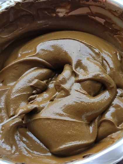 A bowl of my signature henna paste, ready for a bridal order. It's rich, dark, and has the perfect consistency for detailed wedding designs.