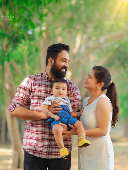 A classic family portrait taken during an outdoor first birthday shoot. We guide you into comfortable poses that feel natural and show your connection.