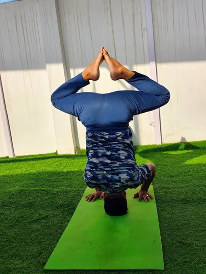 A variation of the headstand, or Sirsasana, with legs in a bound angle pose. This opens the hips while you are inverted.