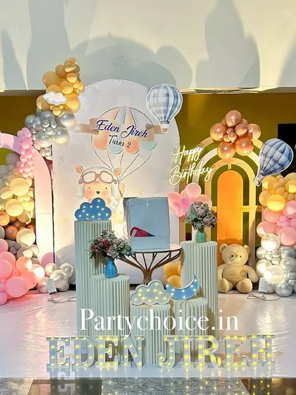 A wider shot of the hot air balloon and teddy bear stage, showcasing the light-up name and the full arrangement of props and balloons.